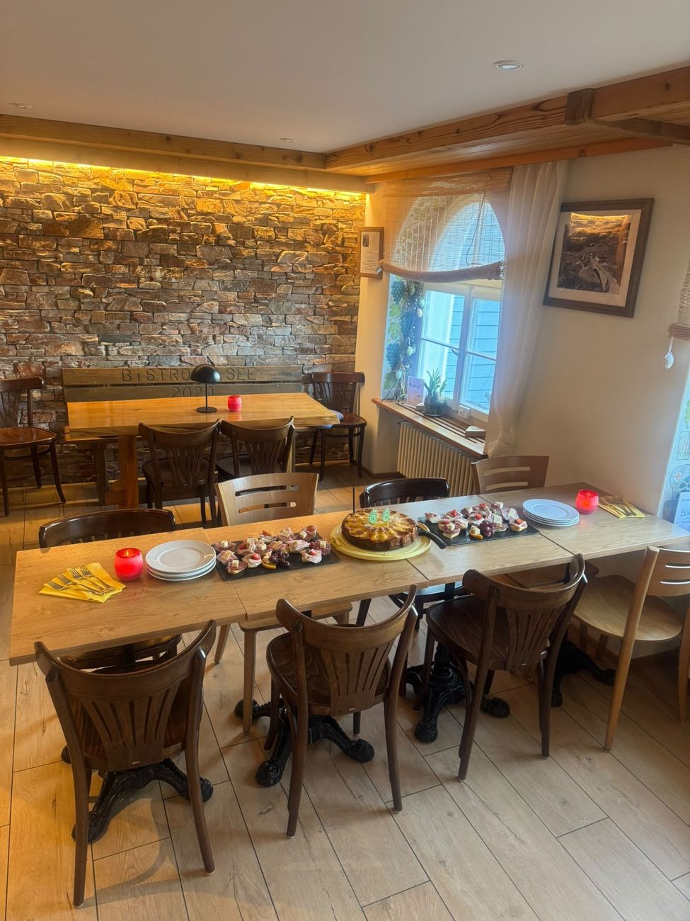 Gedeckter Tisch mit Apéro-Plättli und Geburtstagskuchen im Bistro am See